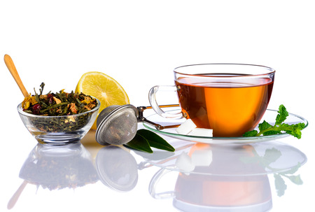 Tea Cup with Tea ingredients, dried herbs and sliced Lemon on white backgroundの写真素材
