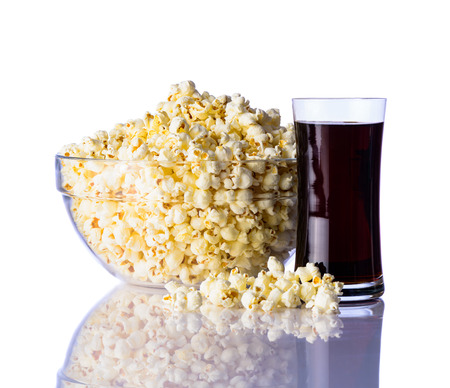 Full Bowl of Popcorn and glass of Cola isolated on white backgroundの写真素材