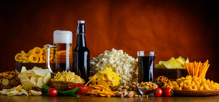Panoramic view of Salty-Snacks and Drinks on wooden Table in still-lifeの写真素材