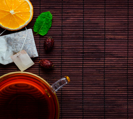 Top Down View of Tea Cup with Tea and Tea-Bag and a sliced Orange with copy-spaceの写真素材