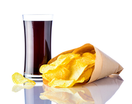 Paper bag of Potato chips and glass of cola isolated on white backgroundの写真素材