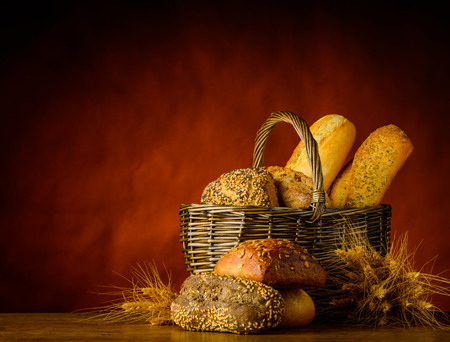 Still life with Basket of bread and Bun with wheatの写真素材