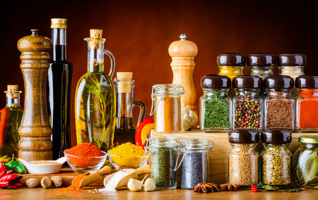 Bottles of oil and Balsamic vinegar and different spices and seeds and cooking ingredientsの写真素材