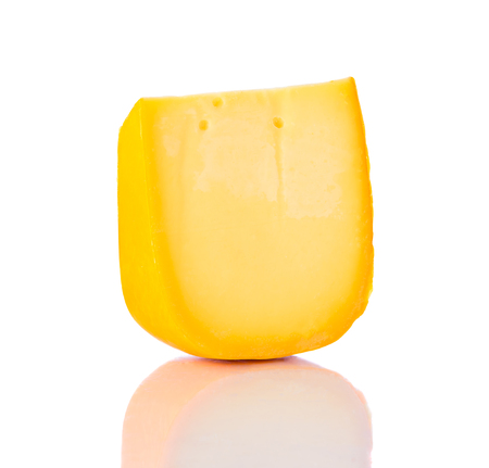 Colby Swiss Cheddar Hard Cheese isolated on white background with reflectionの写真素材