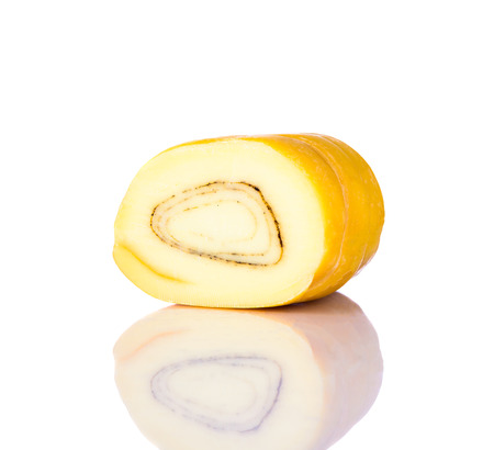 Yellow Rolled Kashkaval Cheese isolated on white background with reflectionの写真素材