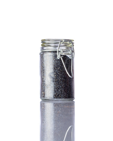 Dark Poppy Seeds in Glass Jar isolated on White Backgroundの写真素材