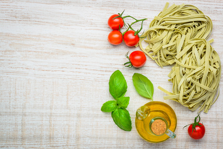 Green Tagliatelle Fettuccine Pasta with tomato and olive oil and copy spaceの写真素材