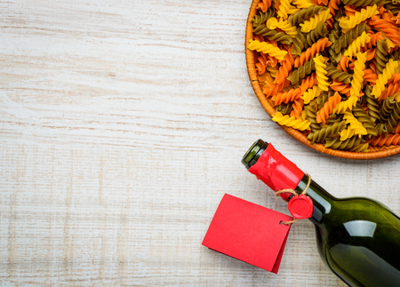 Copy Space with colored Fusilli doppia rigatura and bottle wine with red labelの写真素材