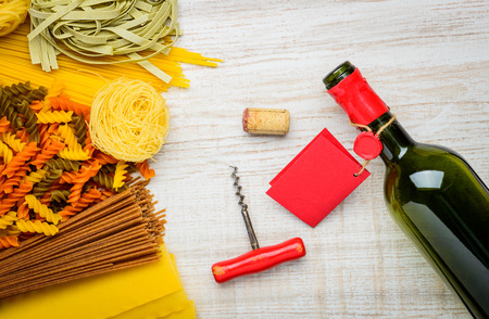 Different Types of Italian Pasta with Bottle of Red Wine with Labelの写真素材