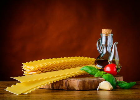 Yellow Reginette Pasta with Olive Oil, Basil and Tomato. Italian Cuisine Lasagna and Seasoningの写真素材