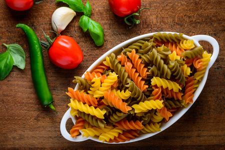 Colored Fusilli Dopia Rigatura Pastao n a white plate. Italian cuisine foodの写真素材