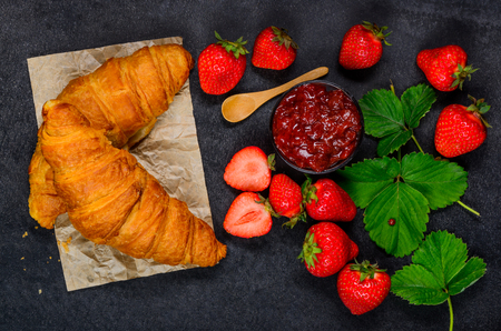 Fresh Red Juicy Strawberries with Strawberry Marmalade Jam and Croissantの写真素材