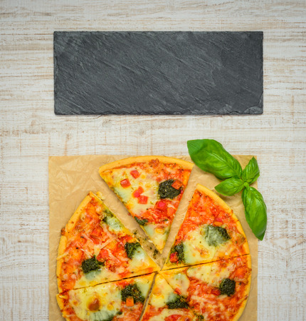 Traditional Italian Pizza sliced and Baked with Dark Plate as Copy Space Areaの写真素材