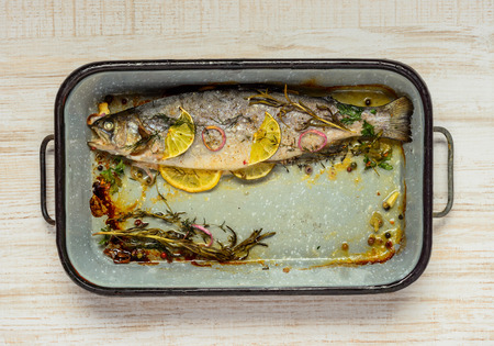 Square Frying Pan with Cooked Trout Fish and Vegetablesの写真素材
