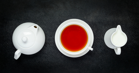 White Teapot with Tea cup and Milk in top viewの写真素材