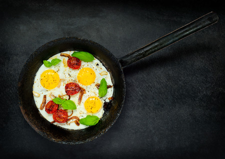 Fried Eggs with Vegetables in Cooking Panの写真素材