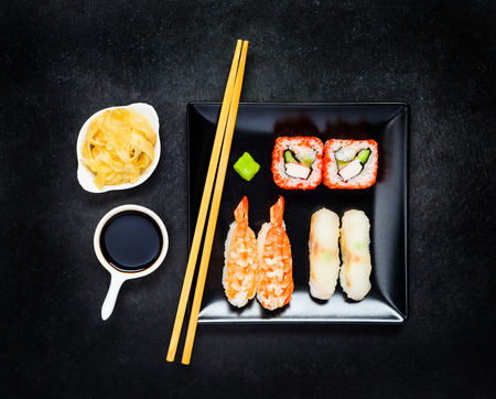 Sushi with Caviar, Surimi and Wasabi on Black Plate. Nigiri with Soy Sauce and Tsukemono Gingerの写真素材