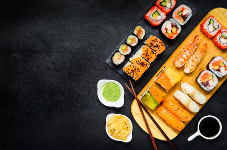 Sushi Rolls with Surimi and Smoked Fish, Wasabi and Tsukemono Ginger with Chopsticks on Copy Space Areaの写真素材