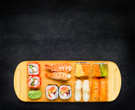 Japanese Cuisine Food with Sushi Rolls, Sashimi, Nigiri and Wasabi on Copy Space Areaの写真素材