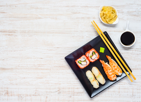 Sushi with Fish and Caviar on Black Plate with Soy Sauce and Ginger Gari on copy Spaceの写真素材