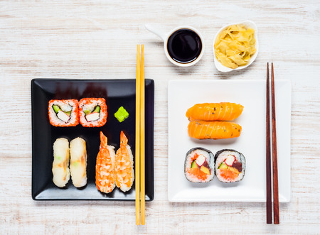 Sushi Rolls and Sashimi on Two plates with Soy Sauce and Ginger Gariの写真素材