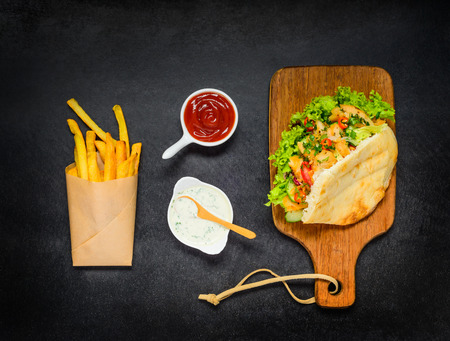 Turkish Sandwich Doner Kebab with Ketchup and Fried Potatoes and Sauceの写真素材