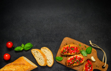 Bruschetta Antipasto with French Bread, Tomatoes and Basil on Copy Space Text Areaの写真素材