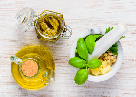 Top View of Pestle and Mortar with Olive Oil and Pesto Jarの写真素材