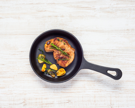Top View of Grilled Steak in Frying Pan with Vegetablesの写真素材