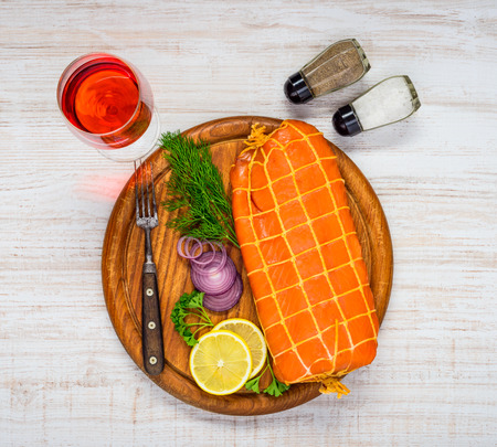 Glass of Rose Wine with Red Smoked Salmon Fish with Lemon and onionの写真素材