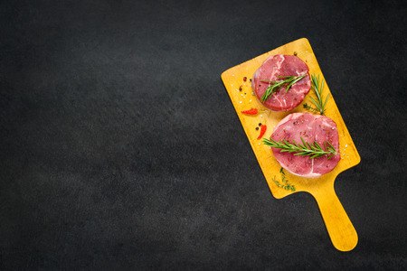 Top View of Raw Meat Beef Chops Spiced and on Copy Space Areaの写真素材