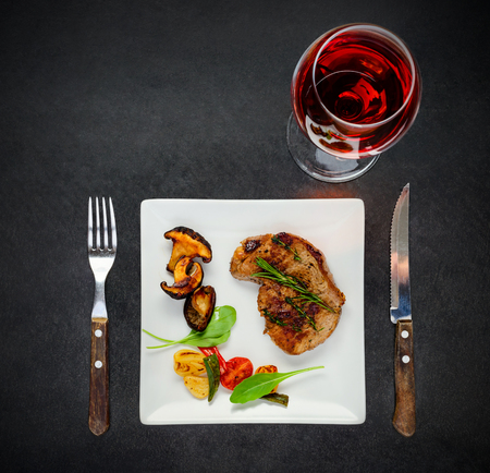 Top View of plate with Mushrooms, Steak Meat and Glass of Rose Wineの写真素材