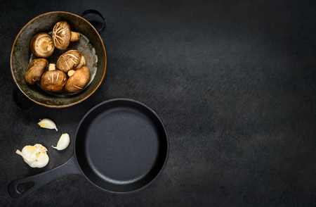 Copy Space with Frying pan, Bowl of Fresh Raw Mushrooms and Garlic in Top Viewの写真素材
