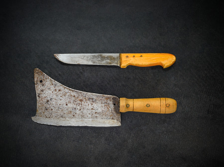 Top View of Butcher Knife and Meat Cleaver on Dark Backgroundの写真素材
