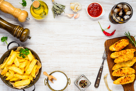 Copy Space Frame Fast Food Fish Fingers and French Fries with Ice Cola Drink and Condiments, Spices and Cooking Ingredientsの写真素材