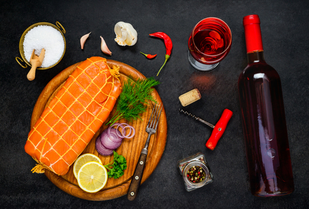 Smoked Red Salmon Fish with Glass and Bottle of Rose Wineの写真素材