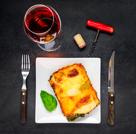 Glass of Rose Wine with Plate of Baked Lasagna Pasta in Top Viewの写真素材