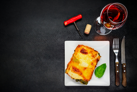 Baked Lasagna and Glass of Rose Wine on Copy Space Text Areaの写真素材