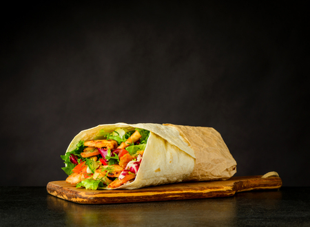 Shawarma Turkish Sandwich with Meat and Vegetables on Dark Backgroundの写真素材