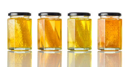 Different Types of Honey with Honeycomb and Isolated on White Backgroundの写真素材