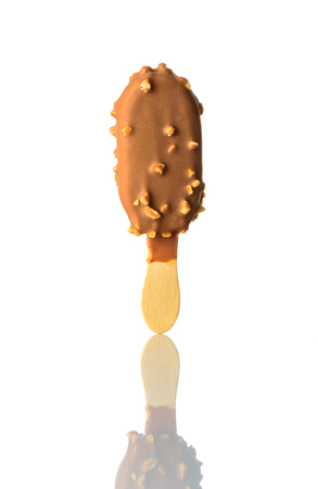 Chocolate Ice Cream with Nuts and Stick on White Backgroundの写真素材