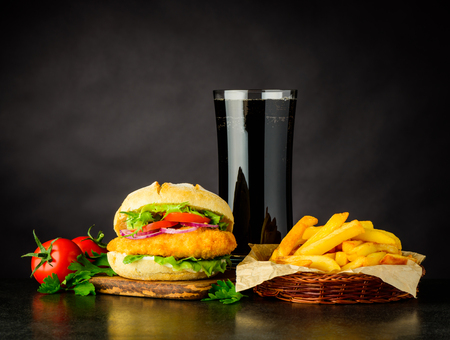 Chickenburger with Cola and French Fries Fast Food on Dark Backgroundの写真素材