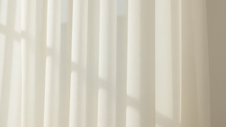 Delicate white sheer curtains catch gentle daylight, casting soft windowpane shadows across the fabric.の素材