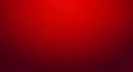 Smooth deep red gradient background with soft central lighting and dark vignette edges. Suitable for web design, presentations, branding and editorial layouts.の素材