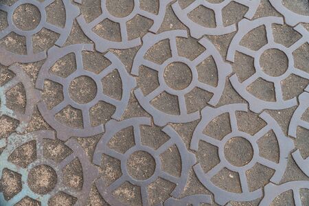 Background image of pavement surface. Wallpaper. Substrate for text. Detailed texture. Idea for exterior and interior. Geometric pattern. Metal gears.の写真素材