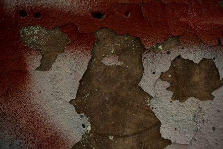 The texture of the old concrete wall covered with paint. Texture of cracked old paint. A background image of a helmet painted wall. Old graffiti on a concrete wall shot at close range. Graphic resources abstract textured background.の写真素材