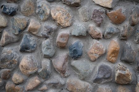 Background image of masonry texture. Texture for interior and exterior. Text space. Wallpaper. Detailed masonry texture. Stone wall. Basement of the building. Ground floor facing. Texture for design.の写真素材