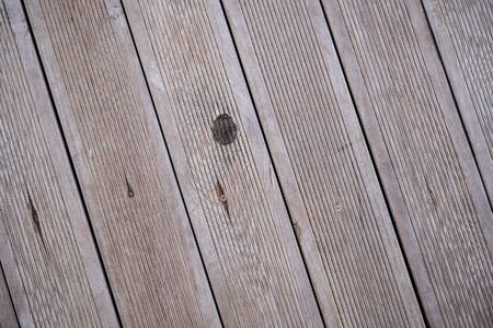 The background image of the floor lined with wooden boards. Wallpaper. Substrate for text. Detailed texture of wood flooring. Wood material in the exterior and interior. Parquet surface.の写真素材