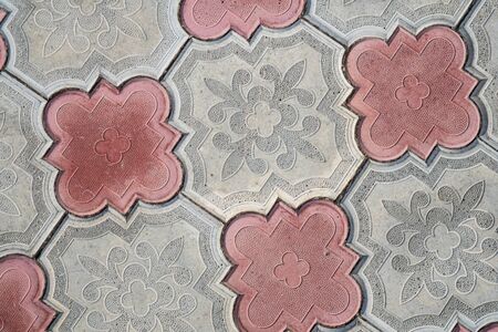 Background image of pavement cover. Detailed texture of paving slabs. Text space. Wallpaper. Footpath cover. Texture for the exterior. Top view. Red and gray paving tiles. Pattern of paving walkway.の写真素材
