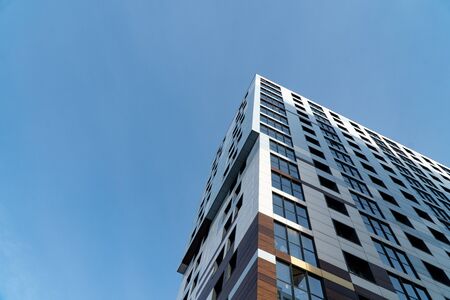 Background image of architectural elements of buildings and structures. Elements and parts of multi-storey offices and shopping centers. The use of reflective glass in construction.の写真素材